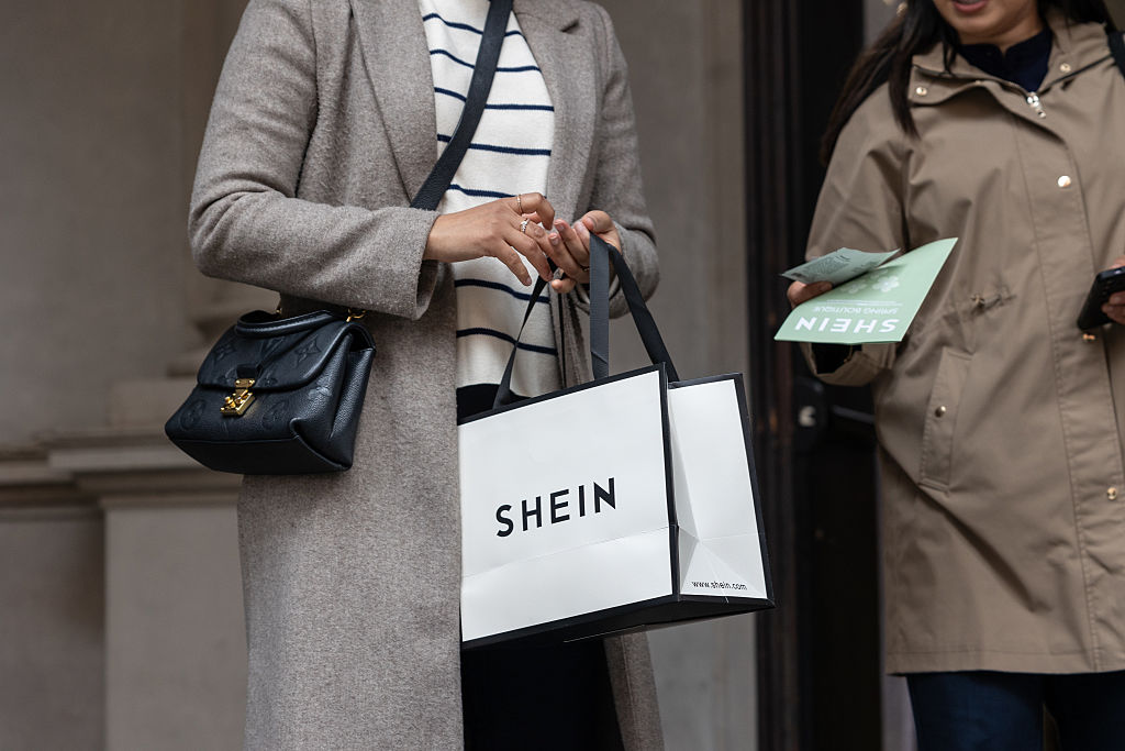 Two women, one of which holding a bag in her hands, leave the SHEIN’s “Spring Boutique” temporary store at Palazzo dei Giureconsulti on March 23, 2024 in Milan, Italy