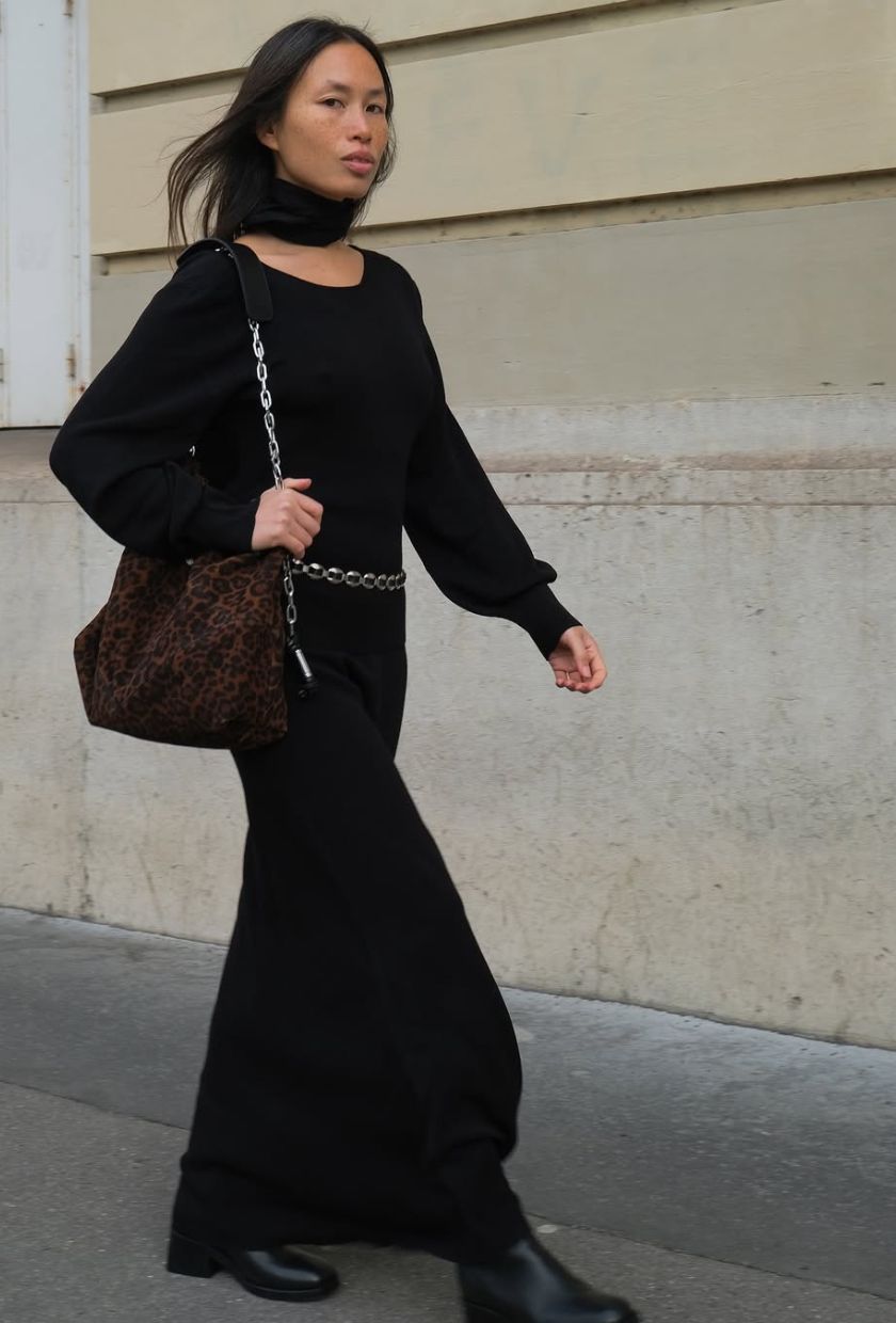 @vikilefevre wears a black knit dress, scarf, brown suede bag and black boots