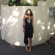 Camelia Farhoodi wearing an asymmetrical dress.