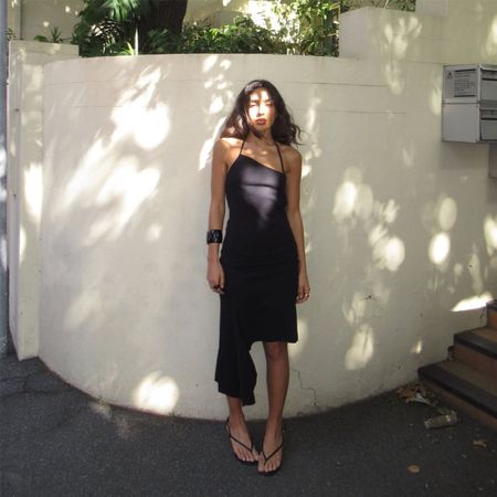 Camelia Farhoodi wearing an asymmetrical dress.