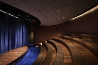 Theatre space in dark wood with blue highlights