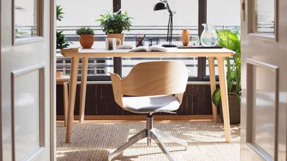 a wooden chair at a desk in a bright airy office, to illustrate the best Amazon office chairs