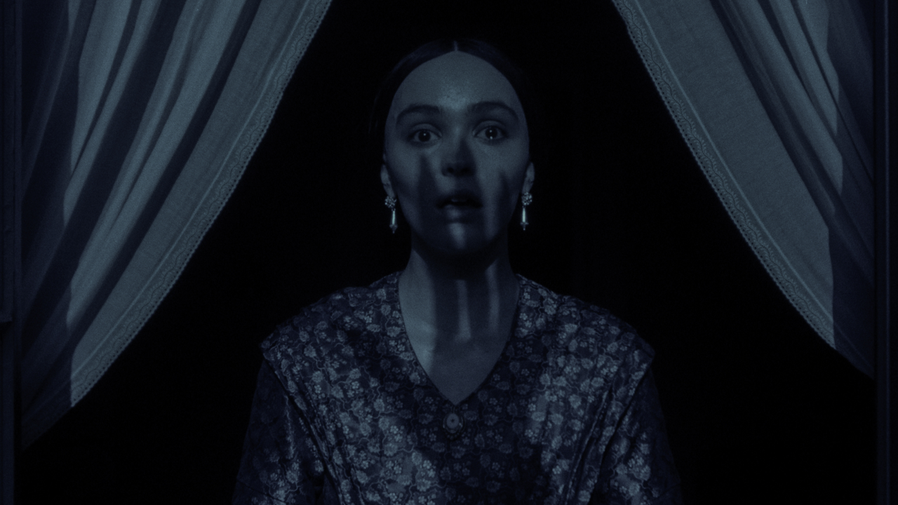 lily rose depp as ellen while she gasps as the shadow of a monster&#039;s hand covers her face in nosferatu