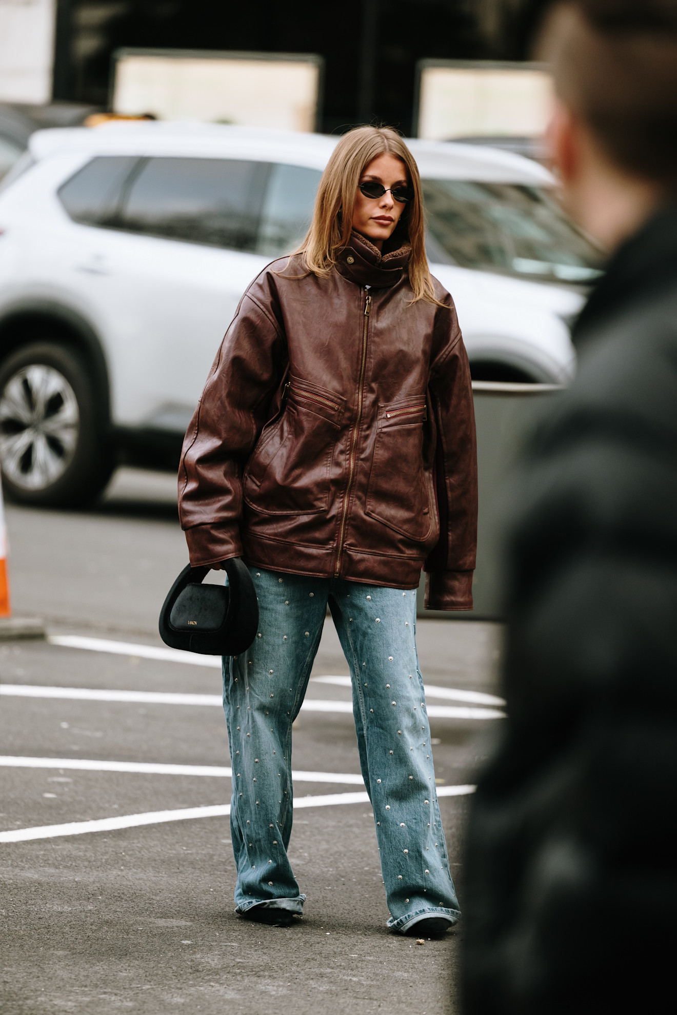PARIS, FRANCE - MARCH 11: Veronica Al Qaisi is seen wearing a white Chanel shirt, Chanel vest, blue embellished Chanel jeans, black studded Chanel bag and black sunglasses the Chanel show during the Womenswear Fall/Winter 2025/2026 as part of Paris Fashion Week on March 11, 2025 in Paris, France. (Photo by Daniel Zuchnik/Getty Images)