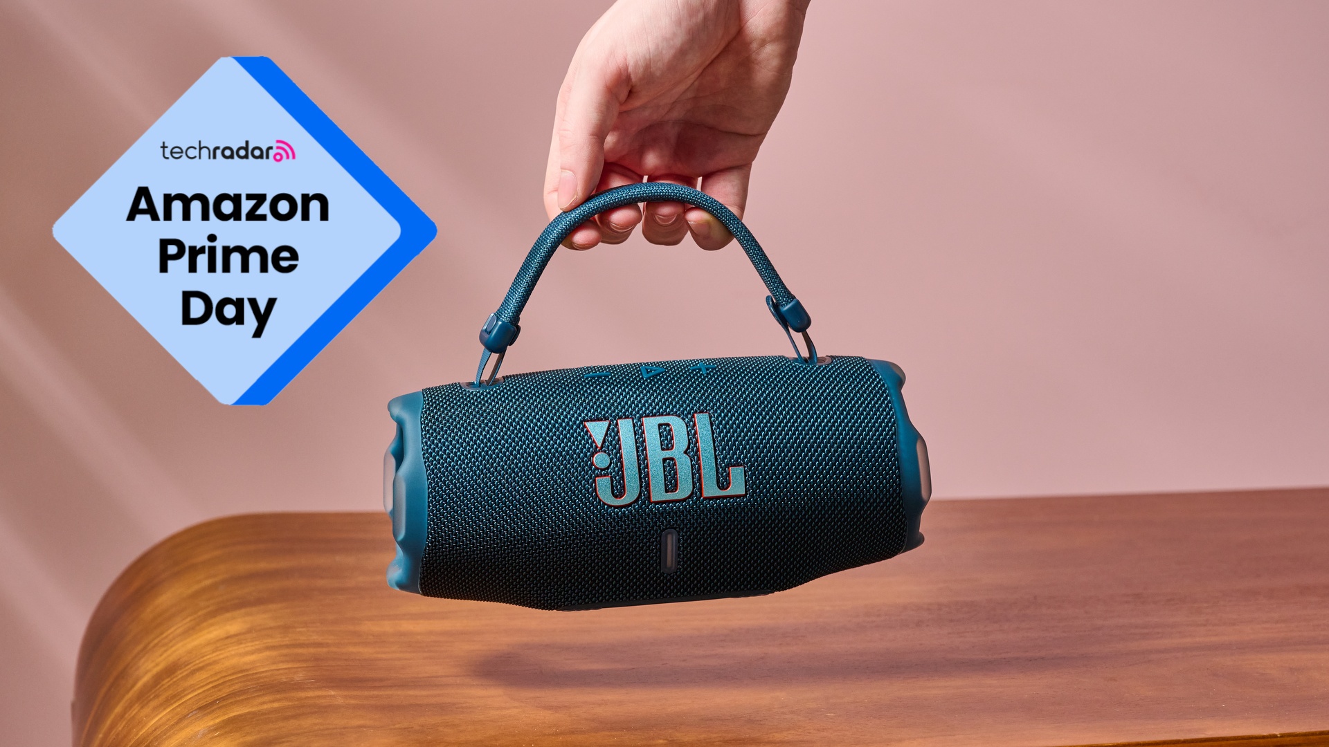 JBL Charge 6 in hand with badge that reads 'TechRadar: Amazon Prime Day'