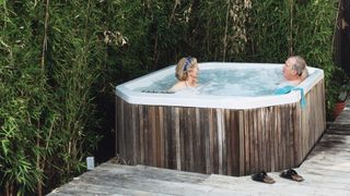 Small backyard ideas: Photo on two people in a hot tub outdoors