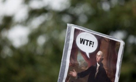 A protester holds a homemade sign featuring the first president George Washington during a Tea party rally in Washington D.C. 