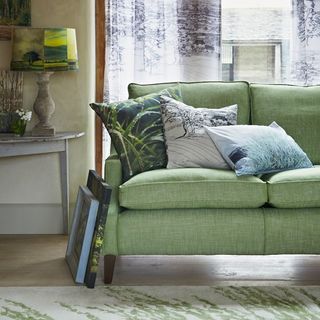Green sofa with patterned cushions