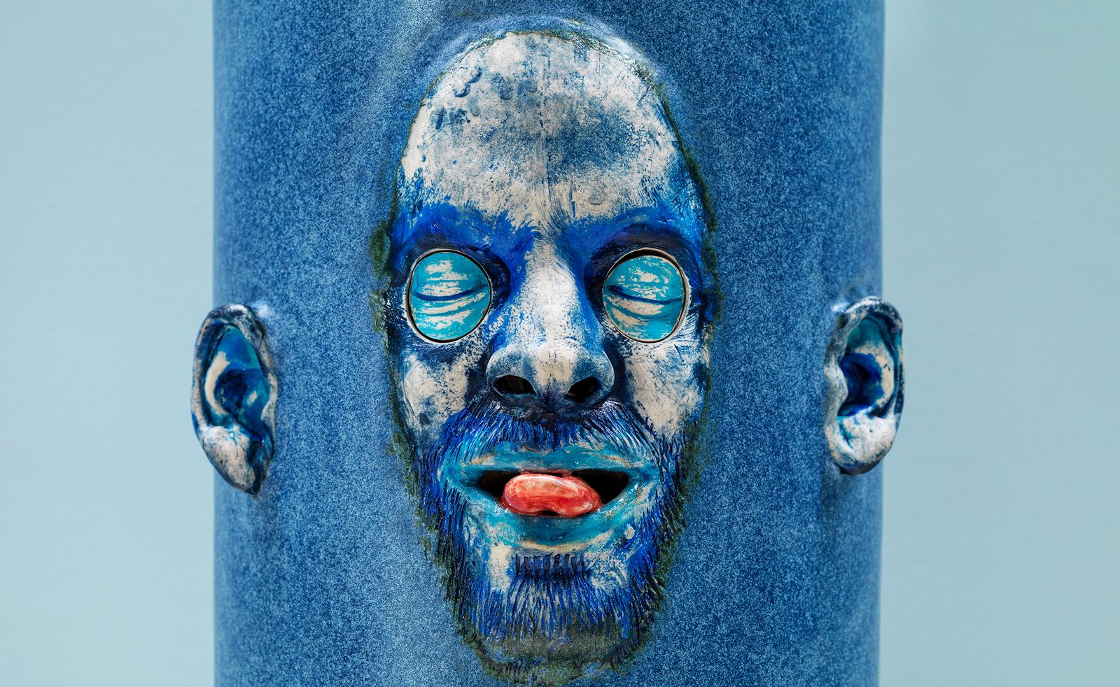 Gruesome blue face sculpture, tongue out
