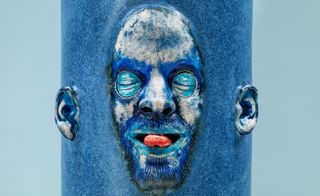Gruesome blue face sculpture, tongue out