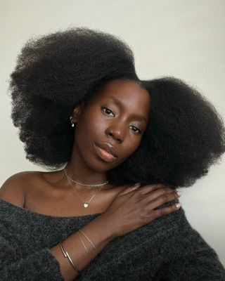 Content creator Danielle Jinadu with dewy-looking skin and natural hair