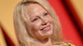 Pamela Anderson with no make up smiling at the 2024 Vanity Fair Oscar party 