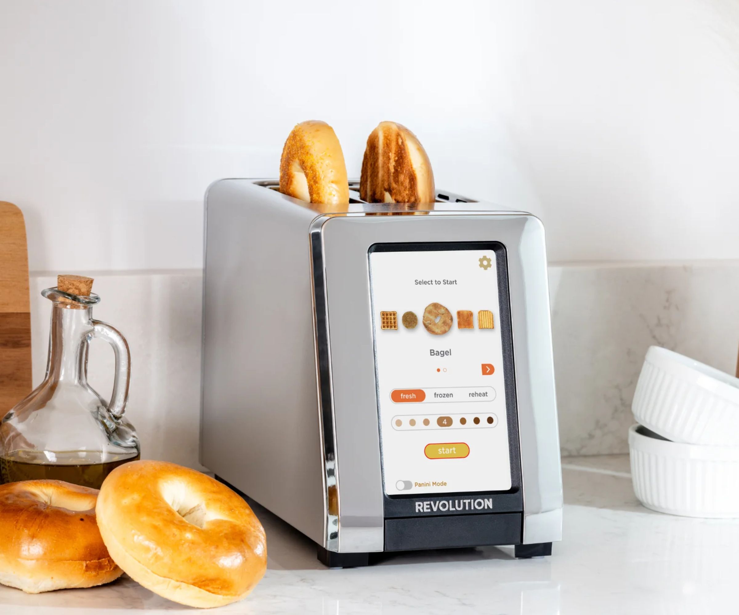 Revolution Smart Toaster on a countertop, toasting bagels