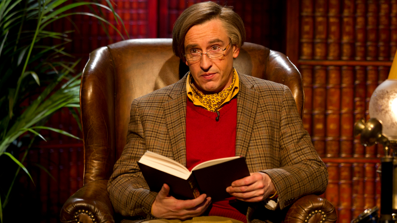 Alan Partridge reading a book