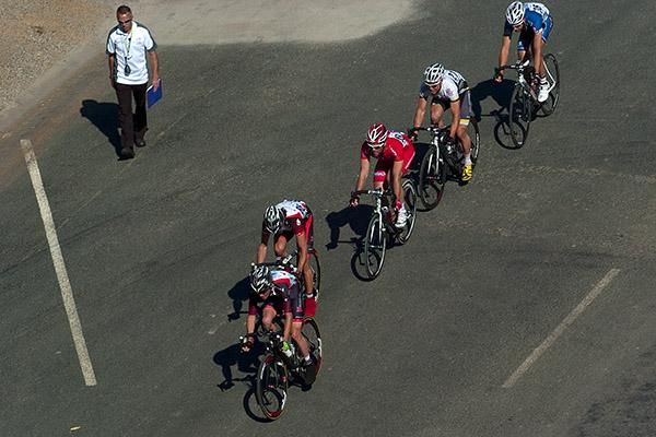 Chief Commissaire Greg Griffiths keeps a close watch on a breakaway group during stage ten in Euston.