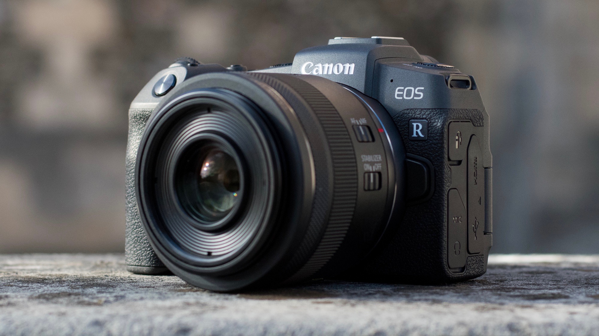 The Canon EOS RP resting on a stone wall