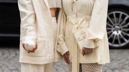 Two fashion week attendees wearing neutral nail looks