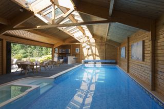 an indoor swimming pool in a timber outbuilding