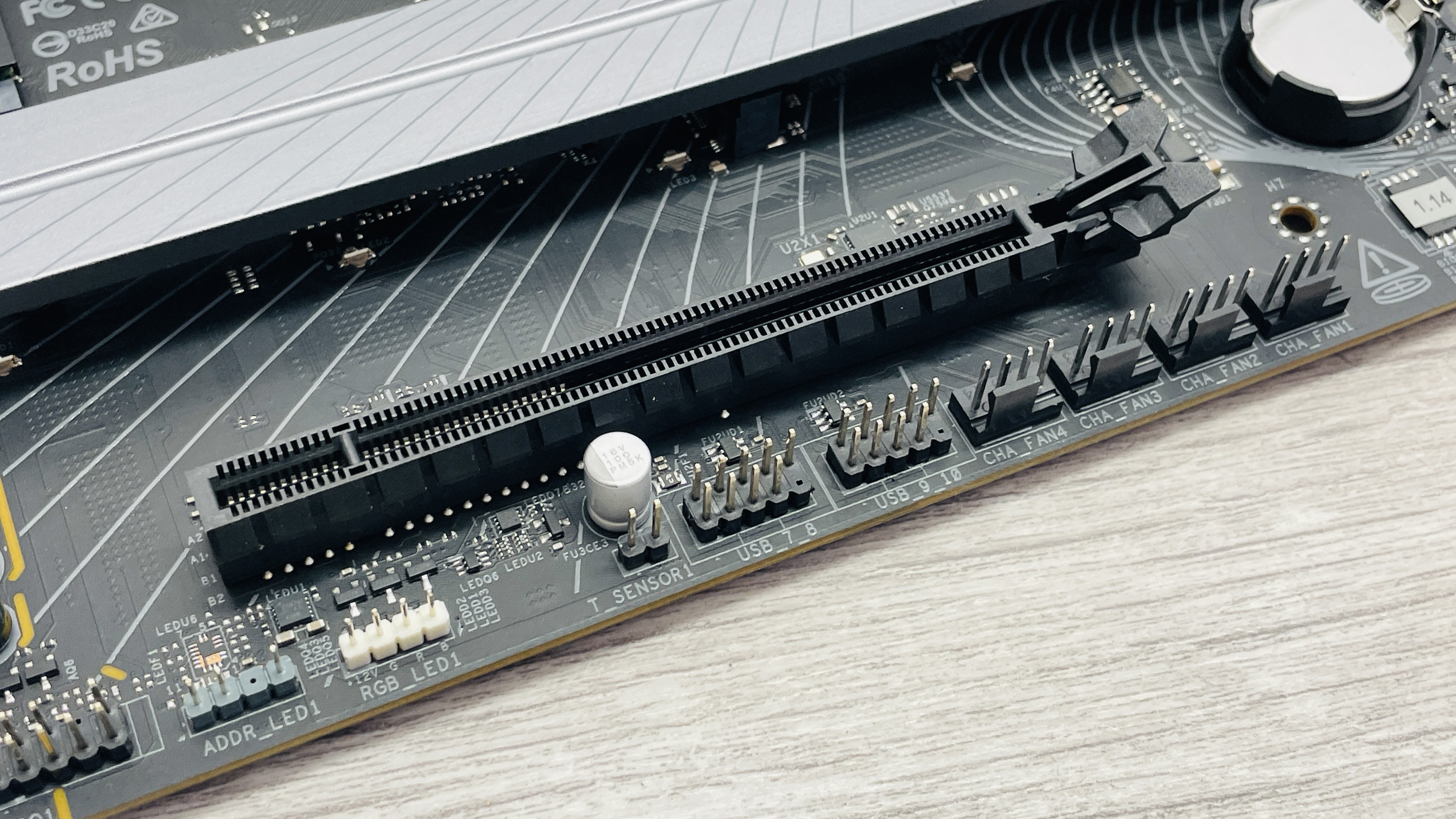 An ASRock B860 LiveMixer Wi-Fi motherboard on a desk.