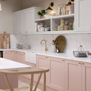 A kitchen with pink and white cabinets