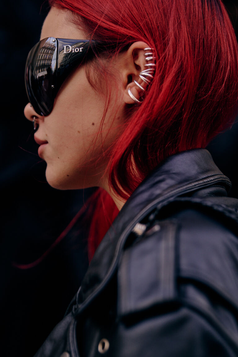 a fashion week guest wearing bug eye sunglasses