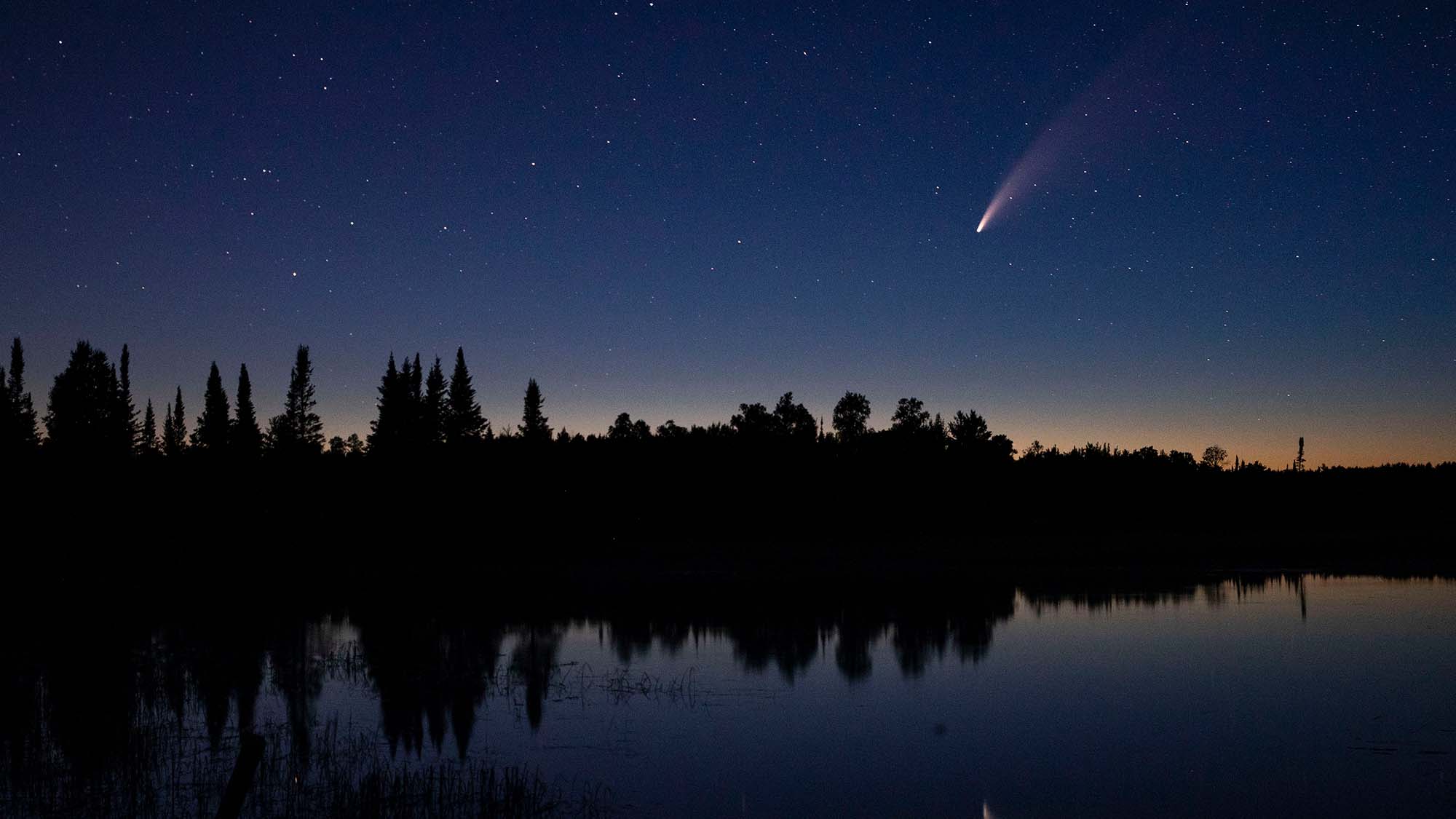 The comet NEOWISE streaked across the night sky over Wolf Lake in Brimson, Minnesota.