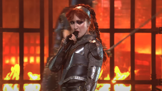 Chappell Roan performing Good Luck, Babe in chainmail and a blazing fire behind her at the 2024 VMAs