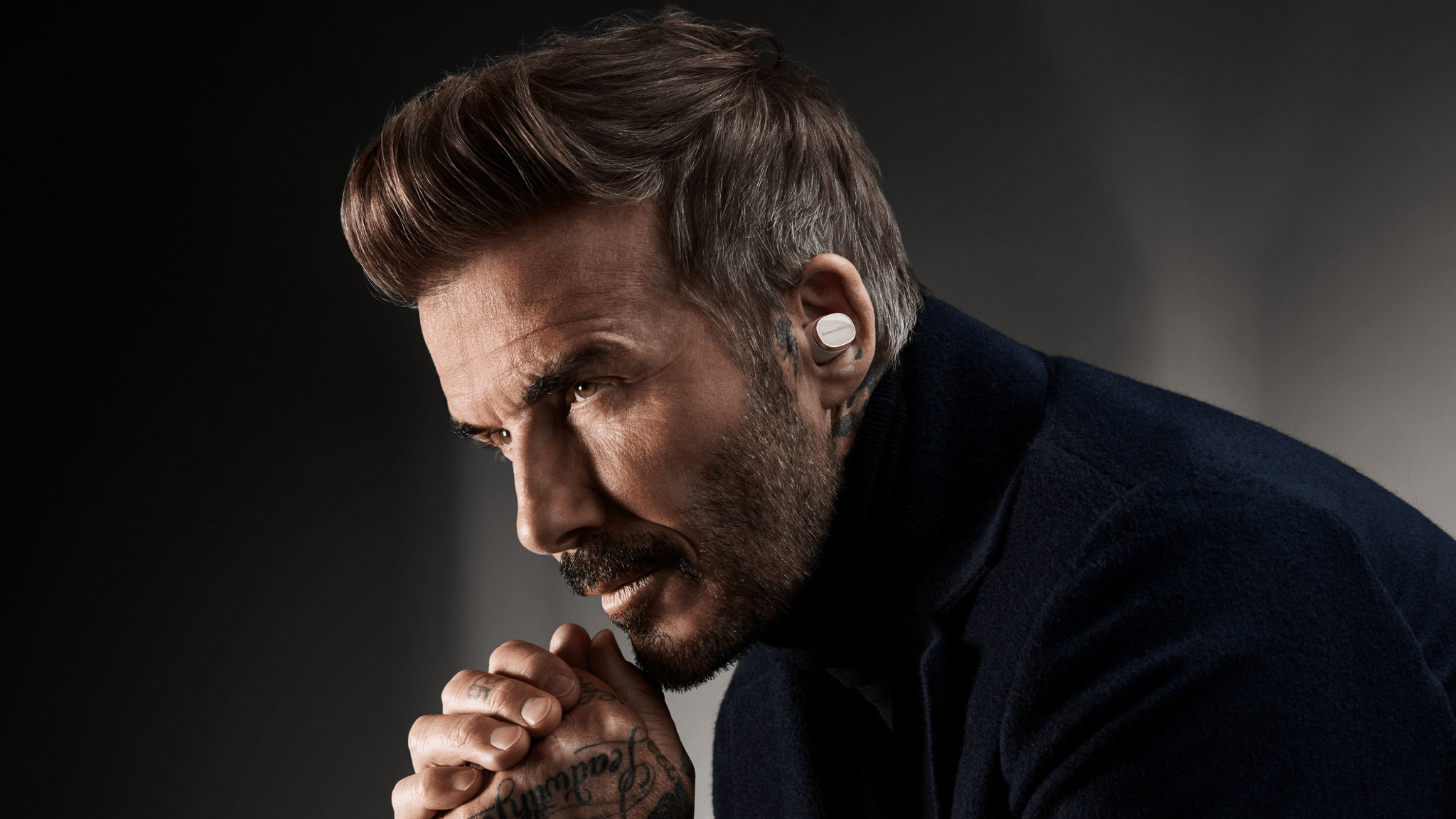 David Beckham wearing Bowers & Wilkins Pi8 earbuds.