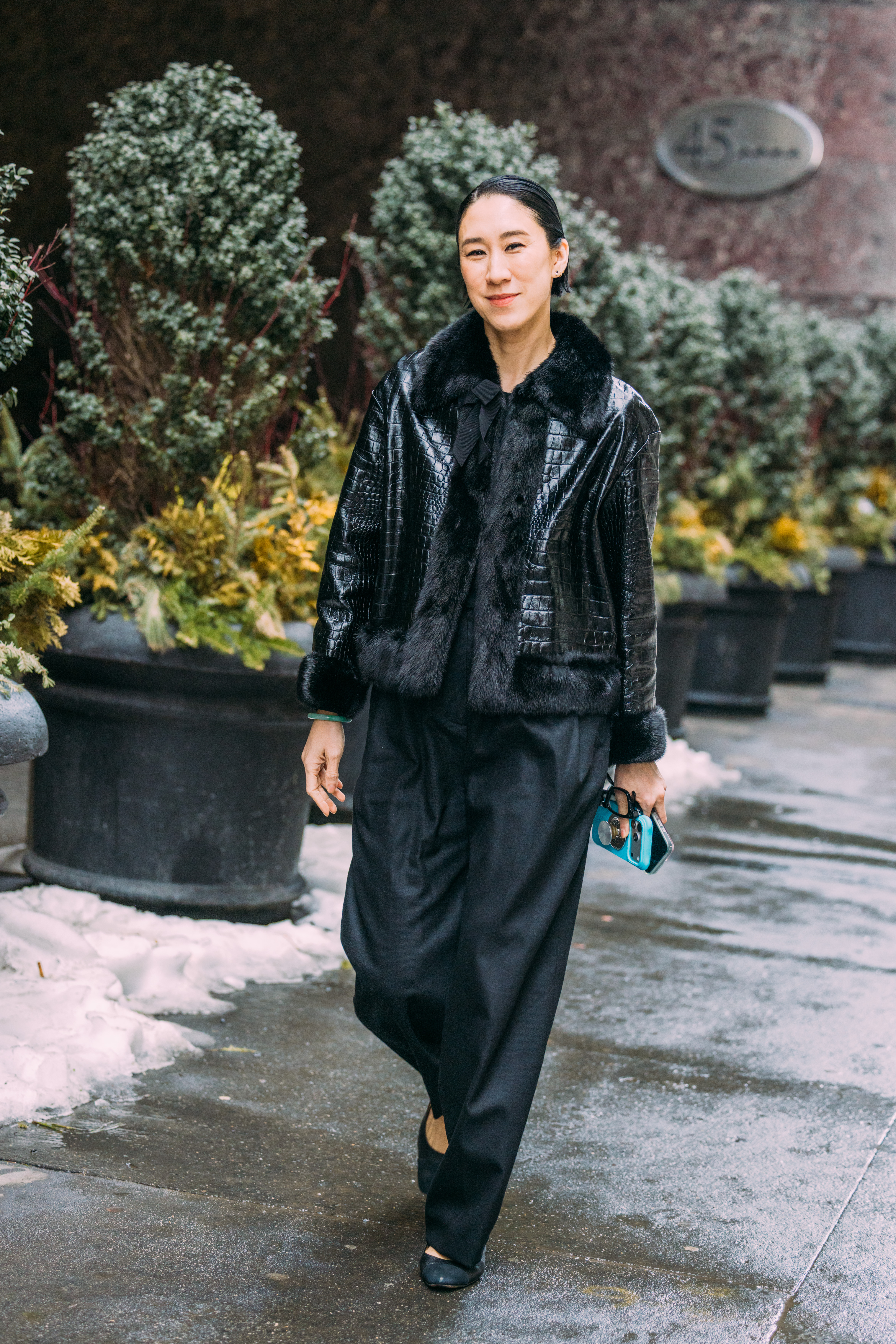 A woman wears black trousers during new york fashion week.