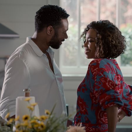 Dion Johnstone as Erik Whitley and Heather Headley as Helen Decatur smiling at each other in a kitchen in sweet magnolias season 4