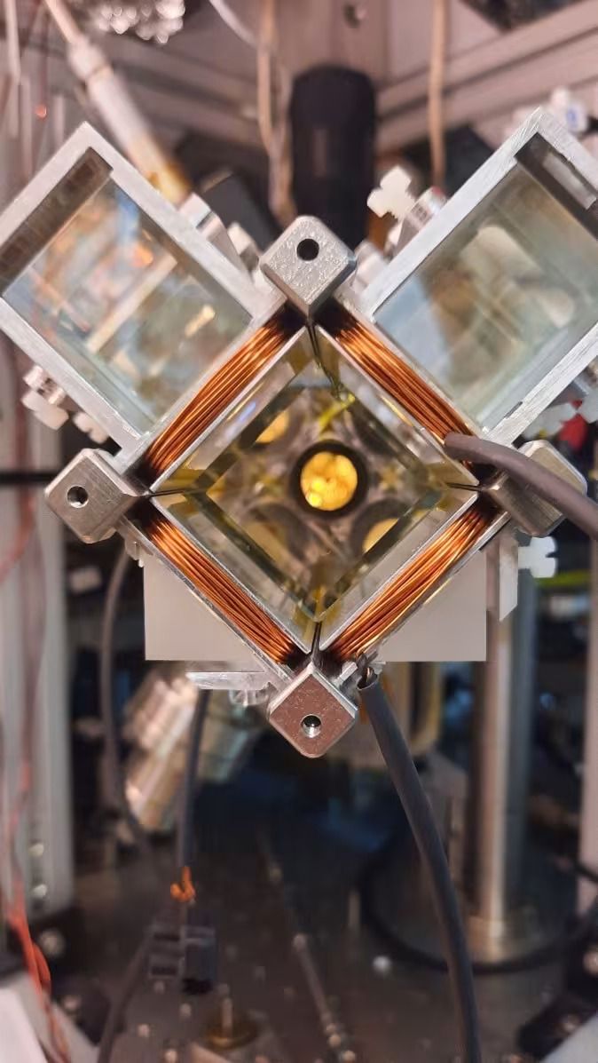 A square of copper coil held up by a series of metal bolts.