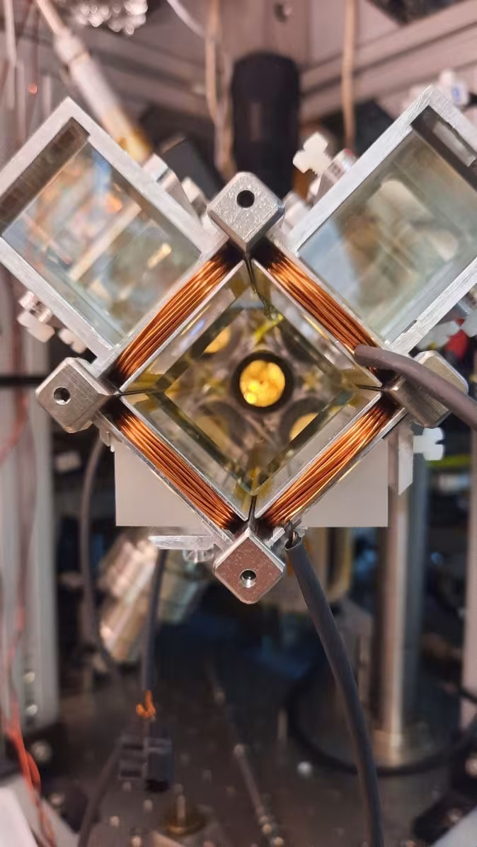 A square of copper coil held up by a series of metal bolts.