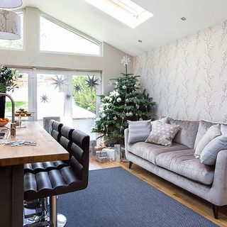 attic kitchen area with sofa and wooden counter table