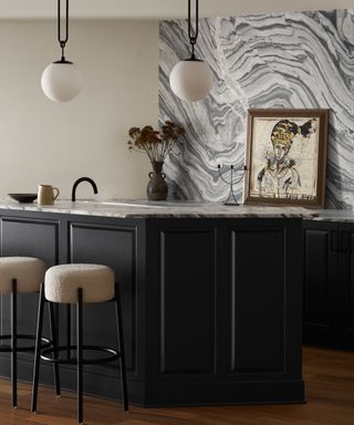 Kitchen with statement marble wall and black island