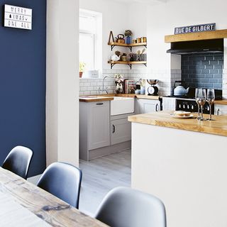 white kitchen diner with blue feature wall