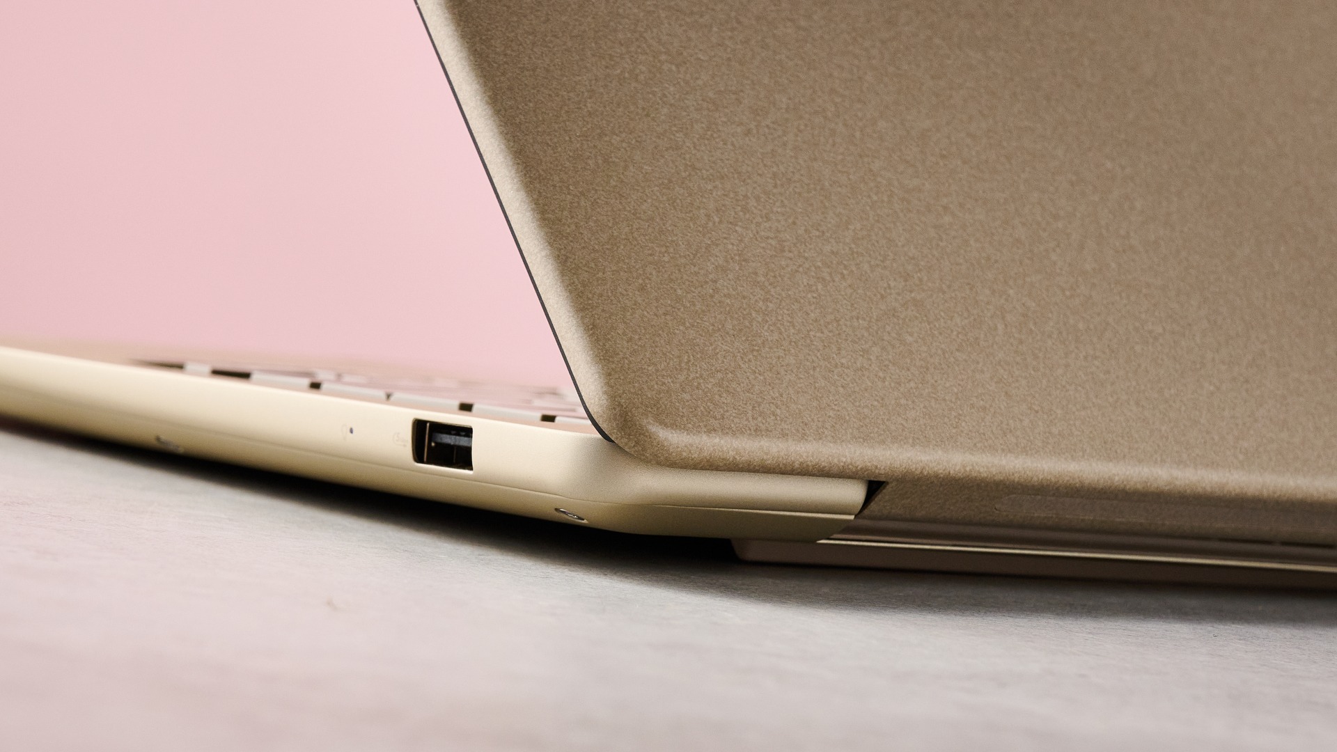 Close-up of rear corner on Asus Zenbook 14 2026 with pink wall in background