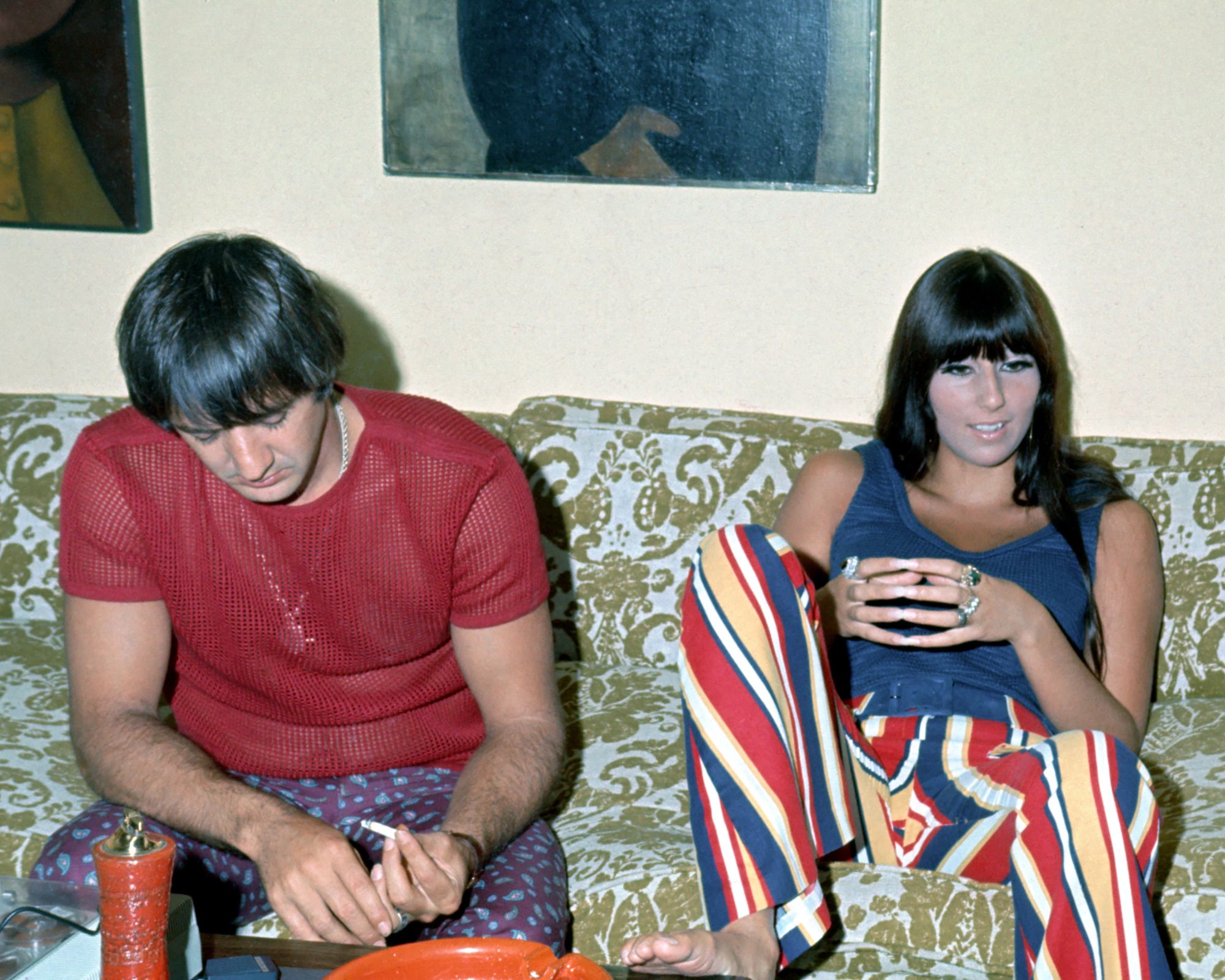 cher and sonny on their green and blue sofa