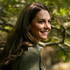 Kate Middleton seen in the countryside posing in the glowing sun while wearing a tweed jacket and a white shirt