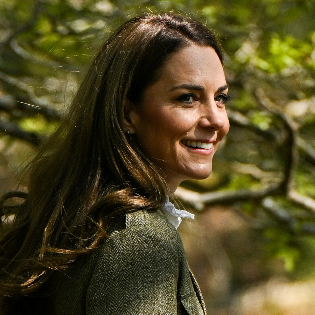 Kate Middleton seen in the countryside posing in the glowing sun while wearing a tweed jacket and a white shirt