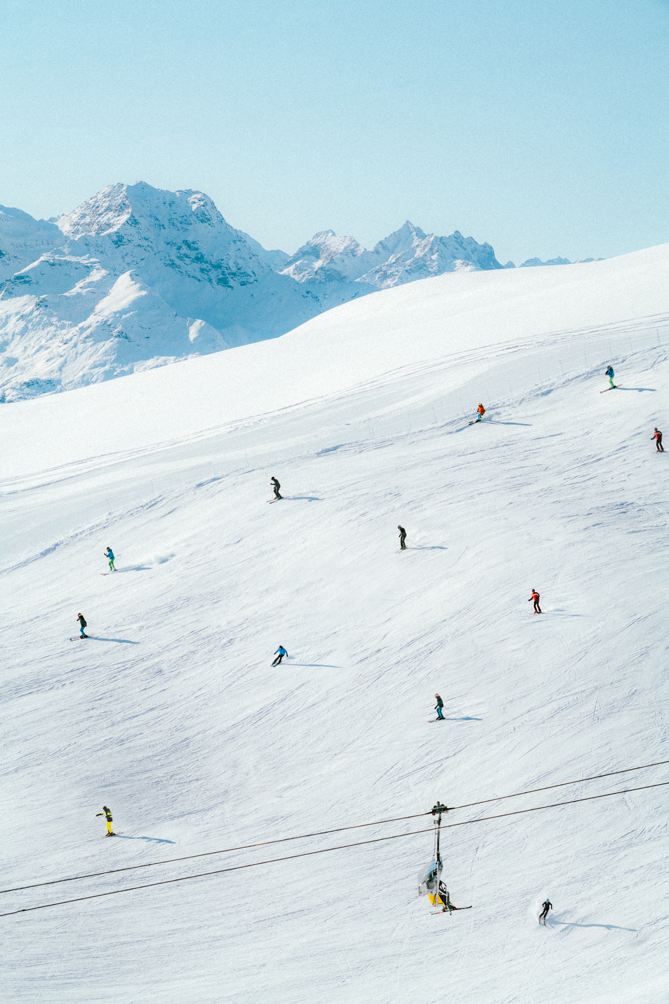 Multiple skiers on a downhill slope