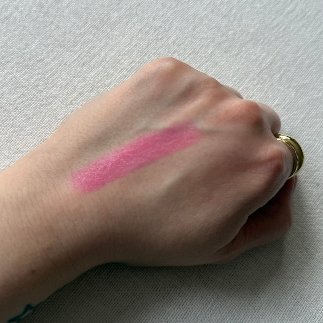 Swatch of the Haus Labs Glassy Blush Balm Stick on the back of a hand