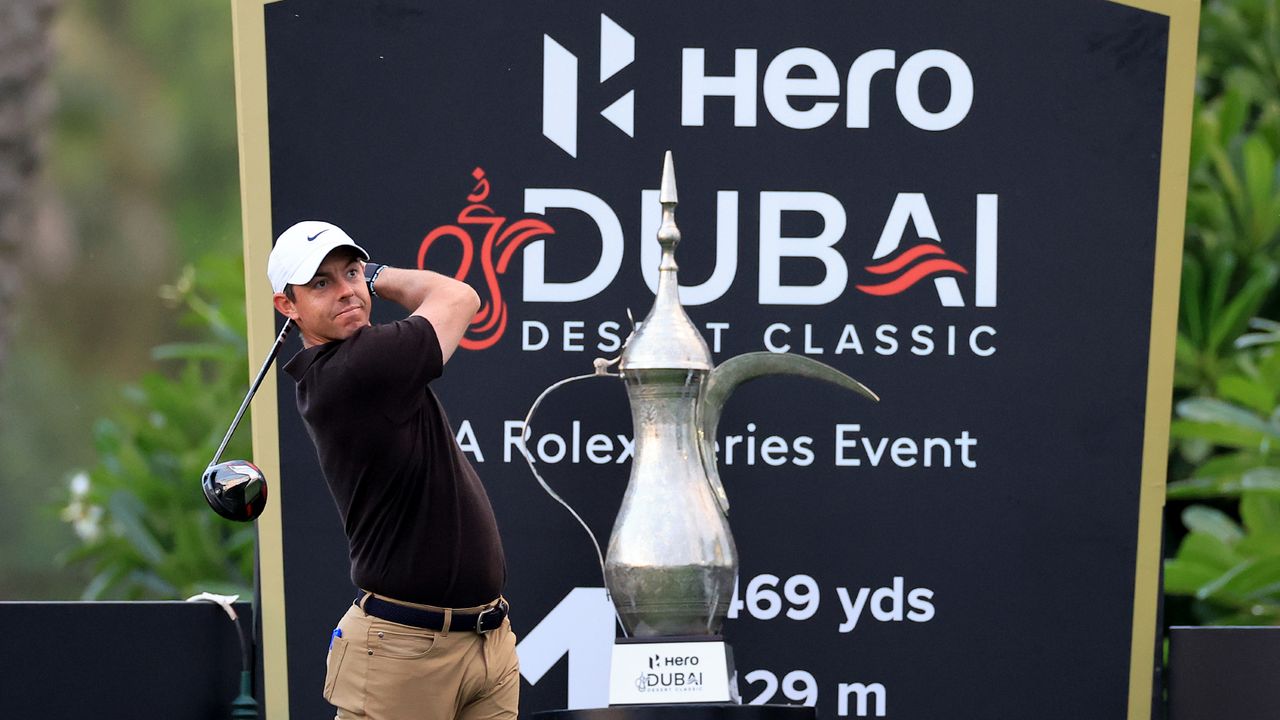 Rory McIlroy takes a shot with the trophy in view during the pro-am before the 2023 Dubai Desert Classic