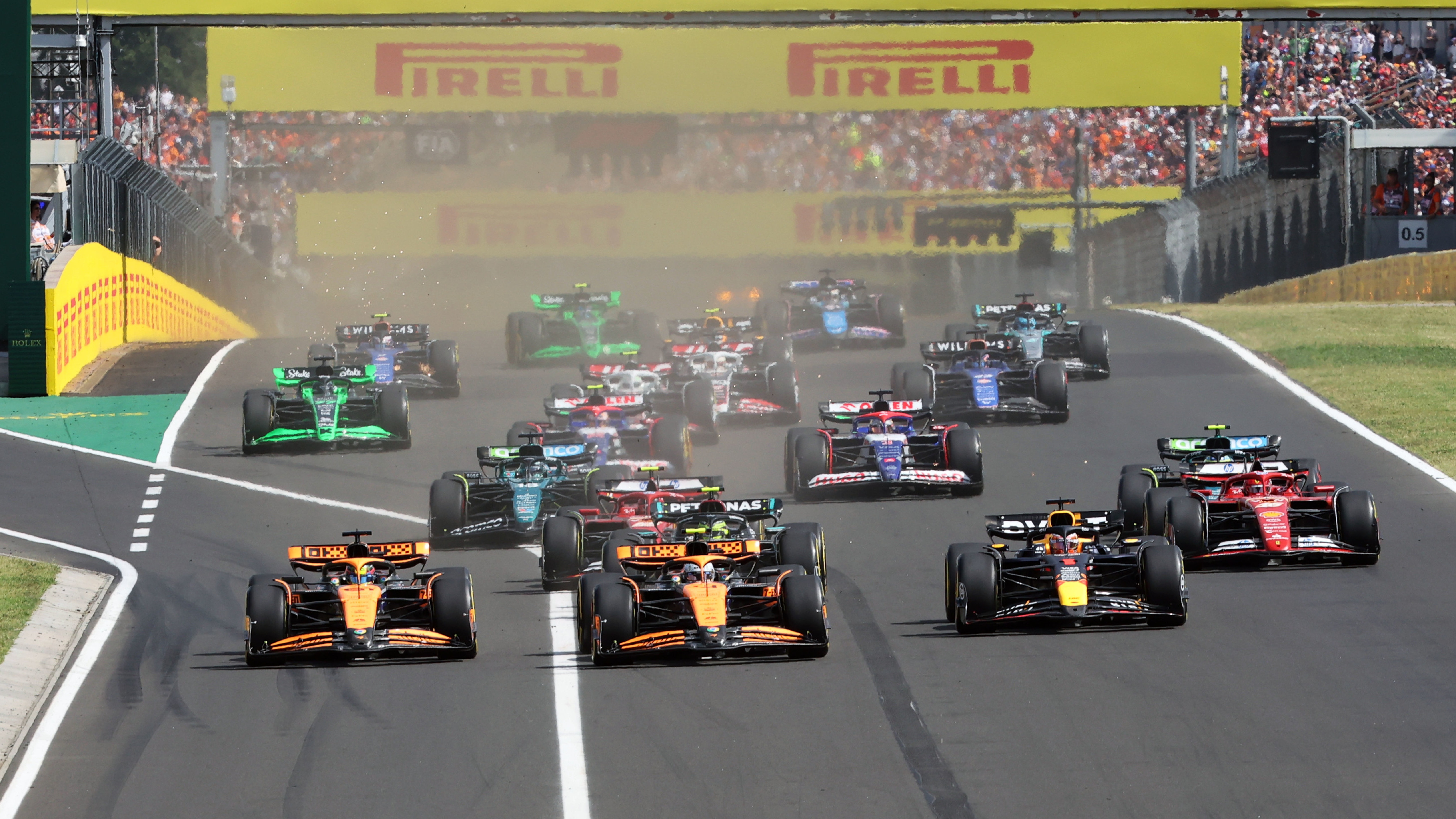 Lando Norris, McLaren MCL38, leads Max Verstappen, Red Bull Racing RB20, Oscar Piastri, McLaren MCL38, Charles Leclerc, Ferrari SF-24, Carlos Sainz, Ferrari SF-24, and the rest of the field at the start during the Hungarian GP at Hungaroring on Sunday July 21, 2024 in Budapest, Hungary.