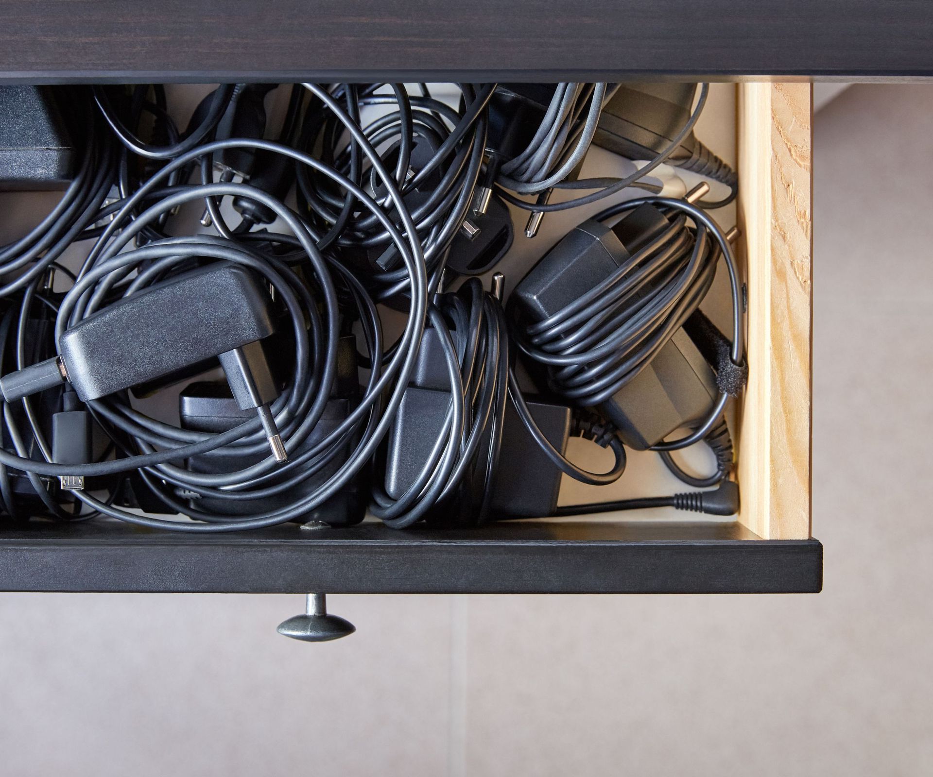 An open drawer full of organized cables