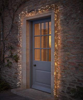 Twinkling fairy lights set around a front door frame