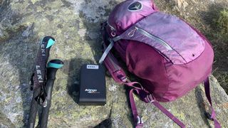 Vango powerbank on a rock next to backpack and trekking poles