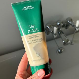 Laura holding Aveda Sap Moss Weightless Hydration Conditioner - best hair conditioners