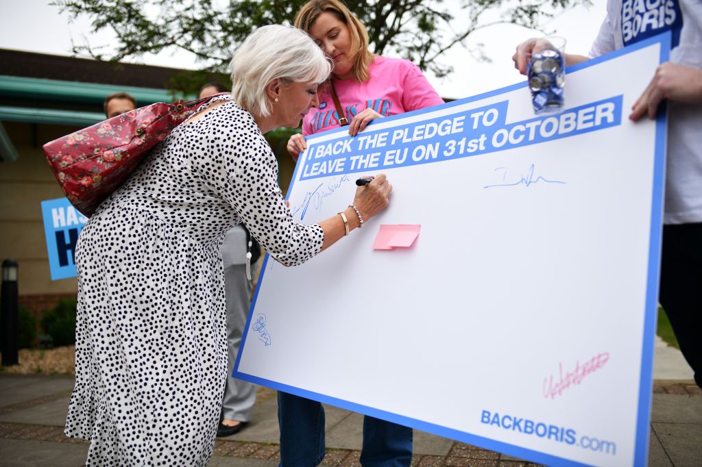 Nadine Dorries signs a poster.