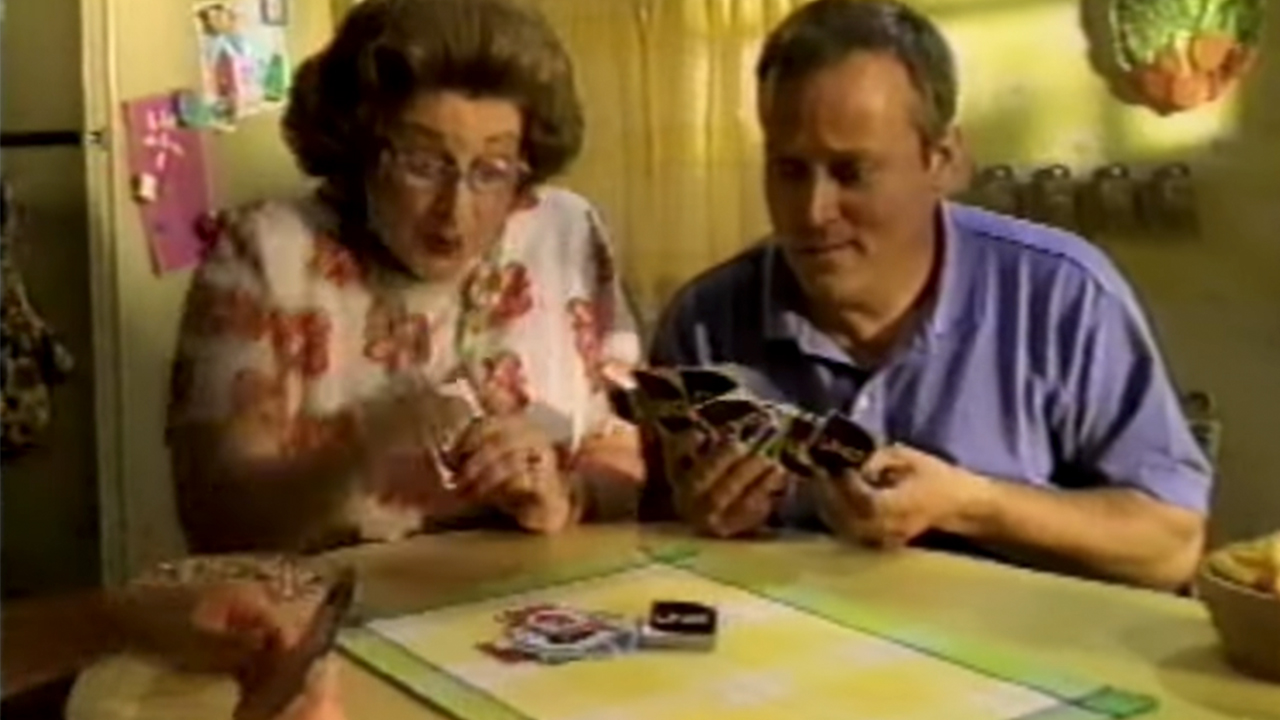 Two people playing UNO in a commercial from the 1990s