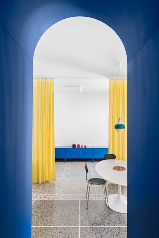 digital blue dining room with yellow doors